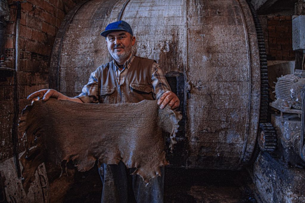 Artisan showcasing leather tanning in Yalvaç, Türkiyes traditional tannery.